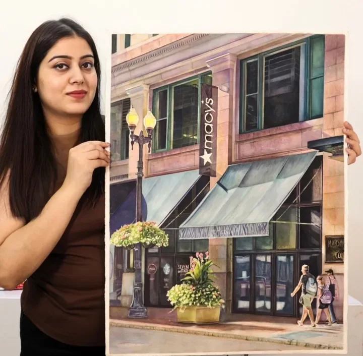 Prerna Joshi with a finished realistic watercolor painting