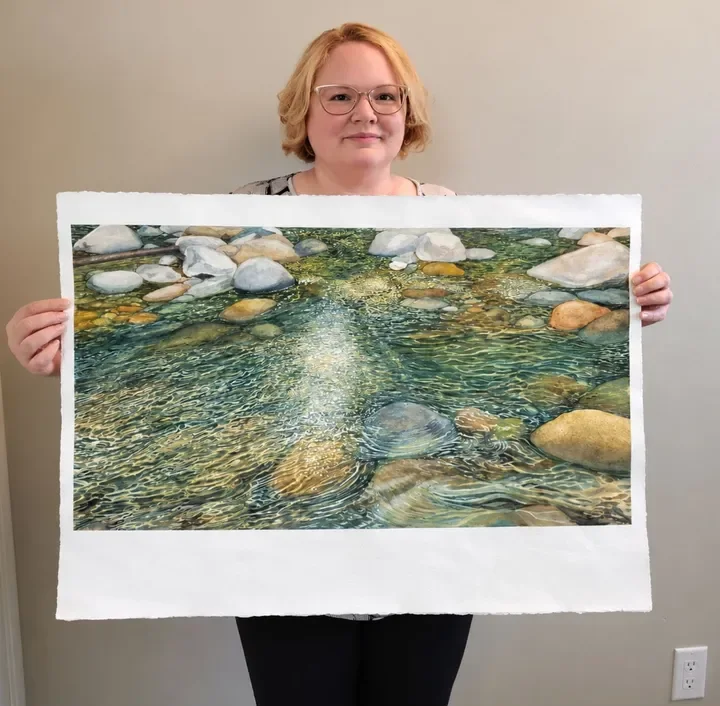 Nora Becker with a finished realistic watercolor painting
