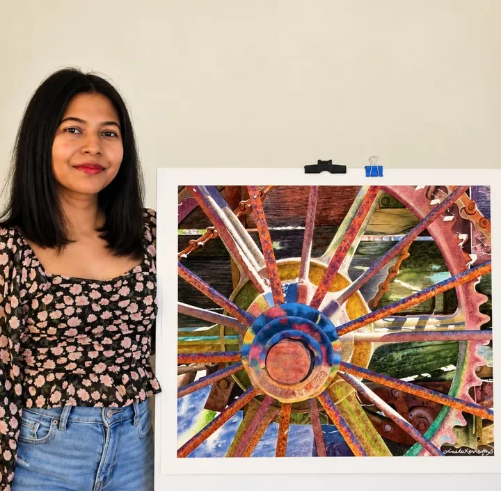 Sneha Kerketta with a finished realistic watercolor painting