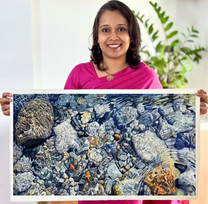 Diya Sudarsanan with a finished realistic watercolor painting
