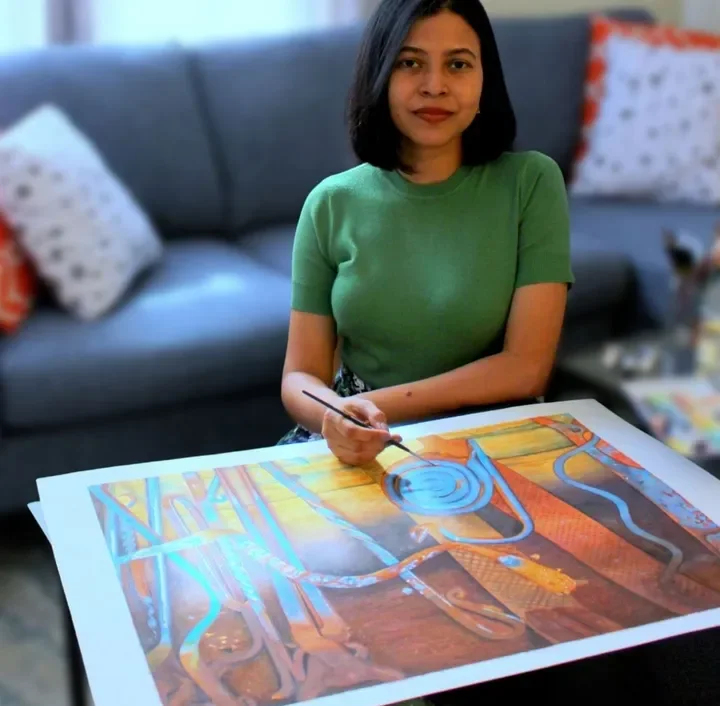 Sneha Kerketta with a finished realistic watercolor painting