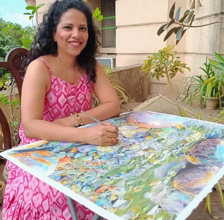 Dhanya Nair with a finished realistic watercolor painting
