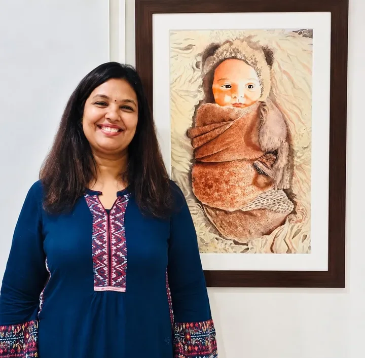 Dr. Amrita Gandhi with a finished realistic watercolor painting