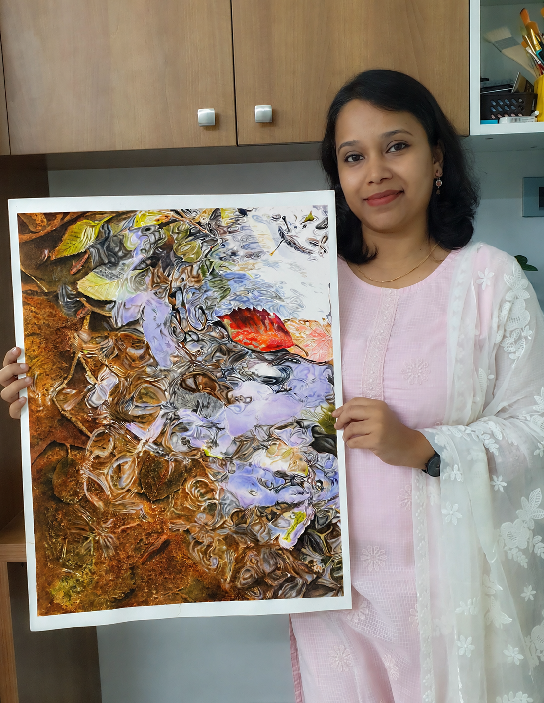 Diya Sudarsanan holding her first Mastering Watercolor Realism project painting