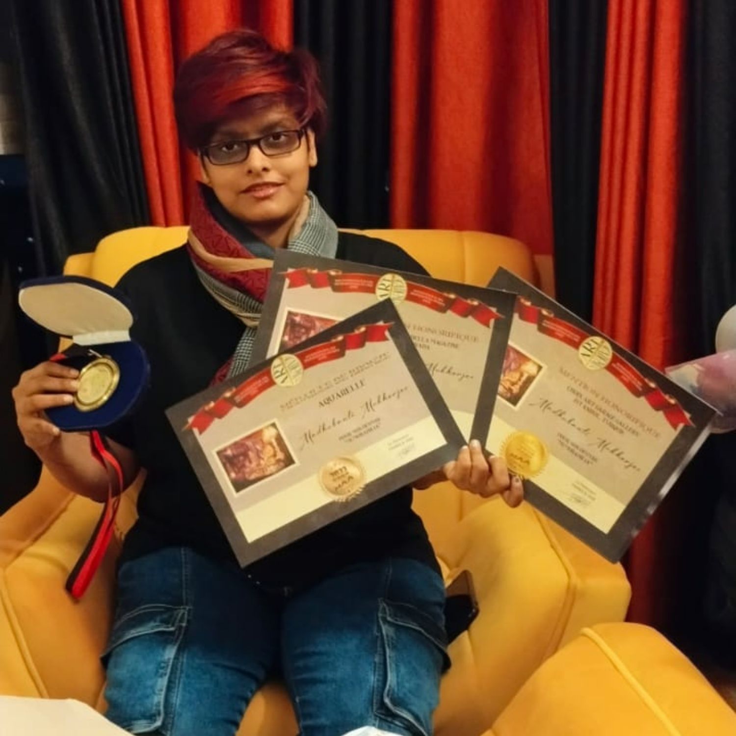 Madhubanti Mukherjee holding her award certificates and medal for Memorabilia