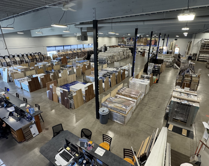 Inside the Floor Trader warehouse with stacked flooring inventory