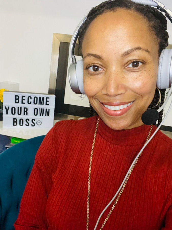 Monica Allen wearing a headset beside a Become Your Own Boss sign