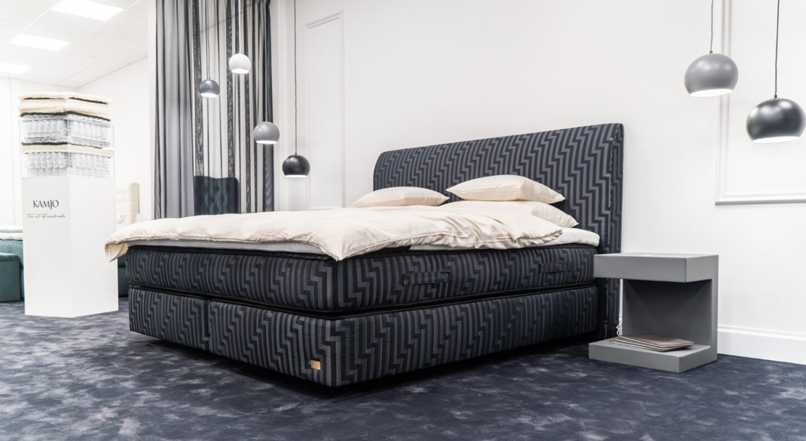 A dressed bed in a bright Cork showroom setting