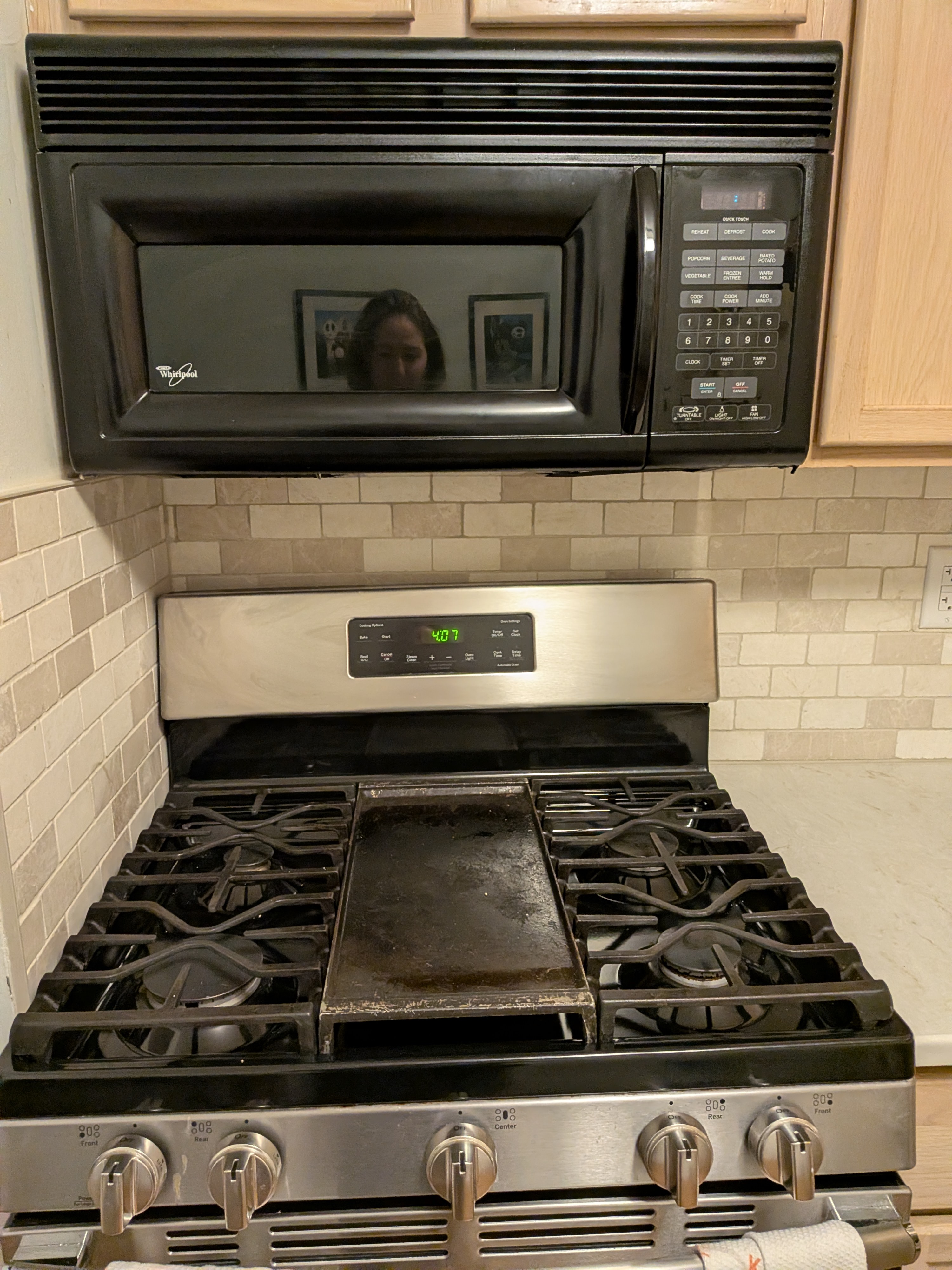 Kitchen with a wall-mounted microwave above a stainless steel stove, installed by Platinum Werx