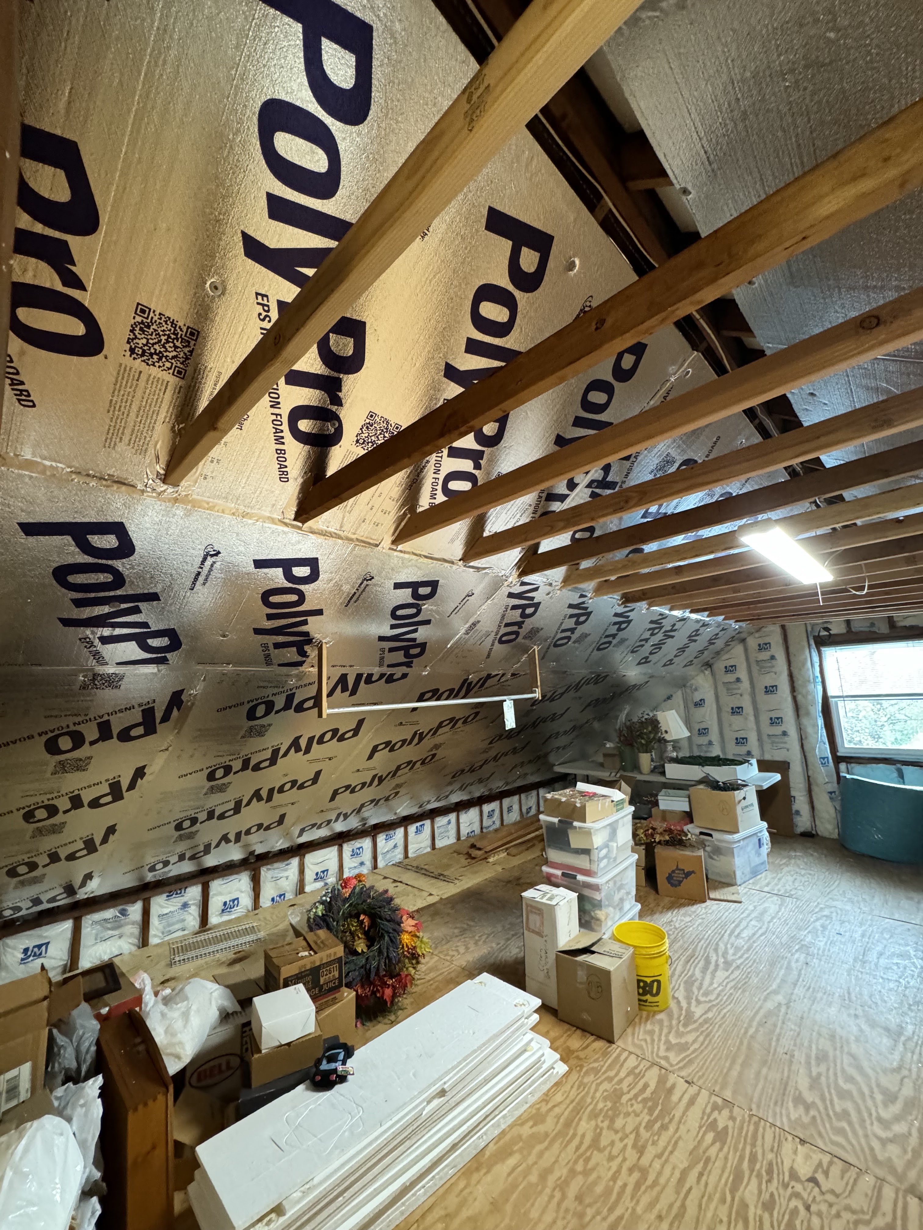 Basement room with wooden framing and insulation board on the ceiling, finished out by Platinum Werx