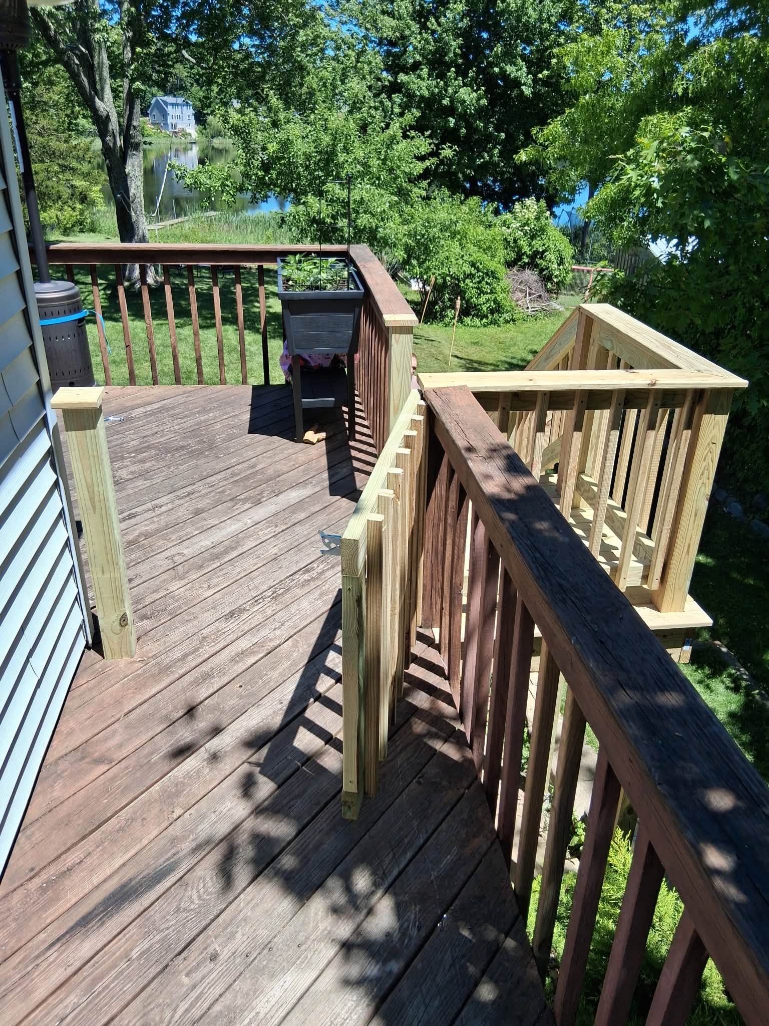 Wooden deck with railing surrounded by trees