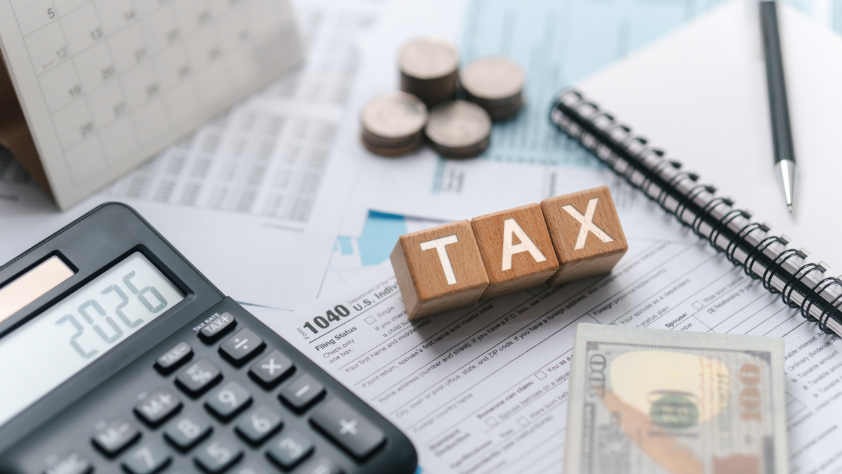 Tax preparation documents with calculator and financial records for small business bookkeeping
