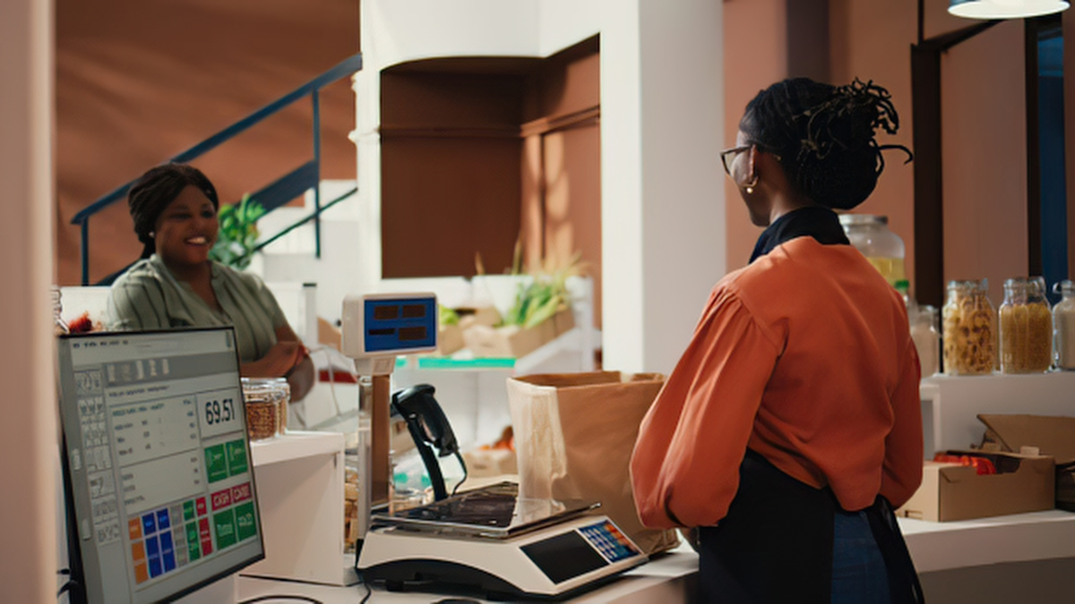 Retail business owner using a point-of-sale system to process sales and manage store transactions