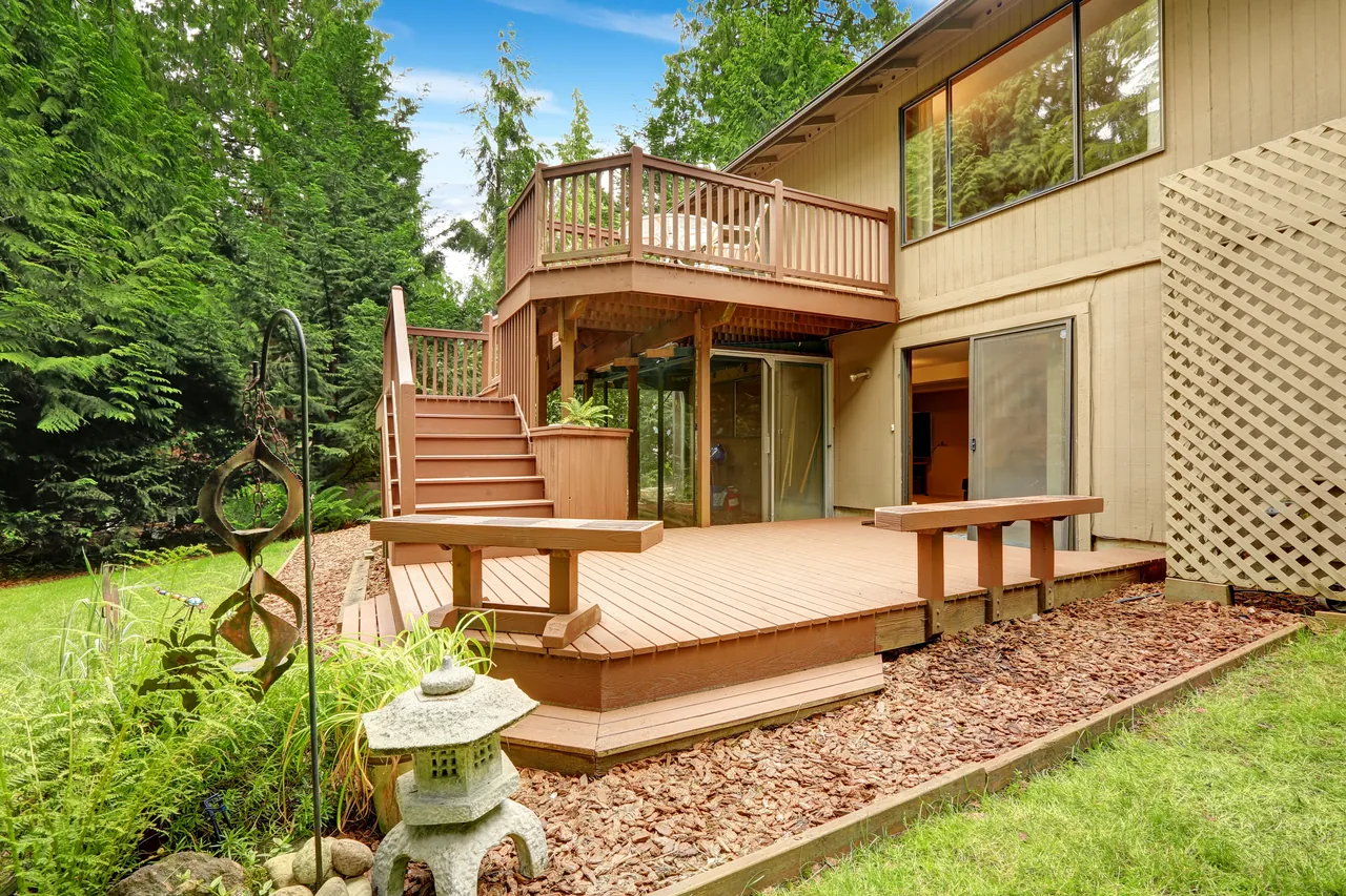 Multi-level wood deck with stairs built onto a home exterior