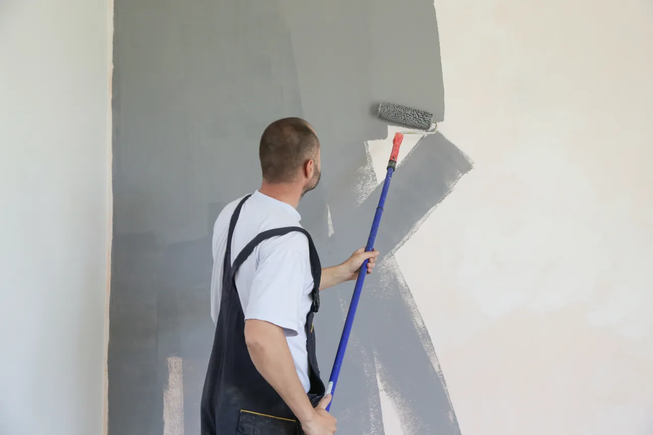 Interior wall being painted with a roller during a remodel