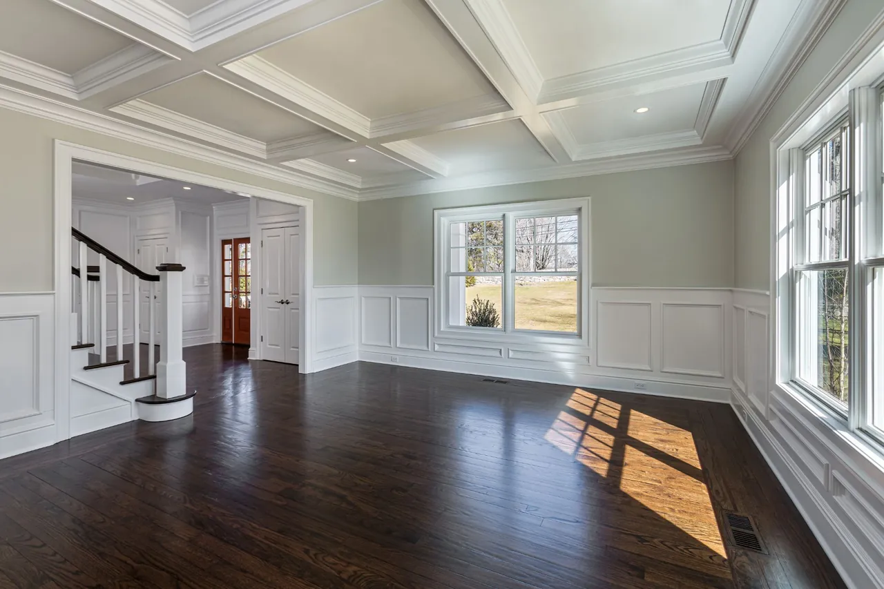 Interior remodel with hardwood flooring, wainscoting, and a coffered ceiling