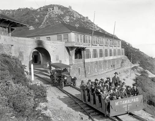 Historic black and white photograph of passengers boarding a Mt. Tamalpais gravity car outside the Tavern of Tamalpais, circa early 1900s.