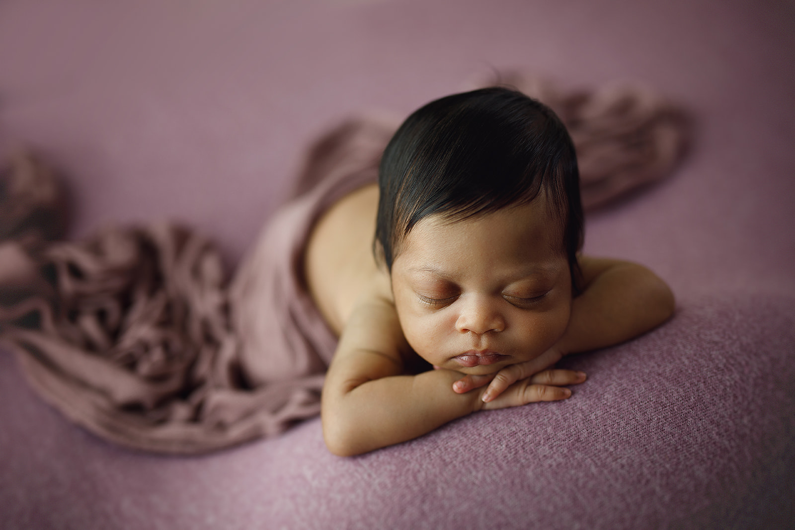 Mauve posed newborn