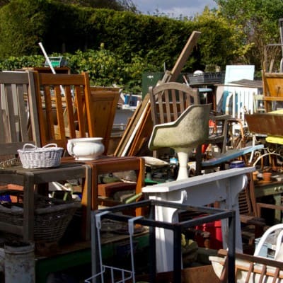 Piled chairs and furniture for junk removal service