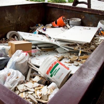 Dumpster filled with construction materials and trash