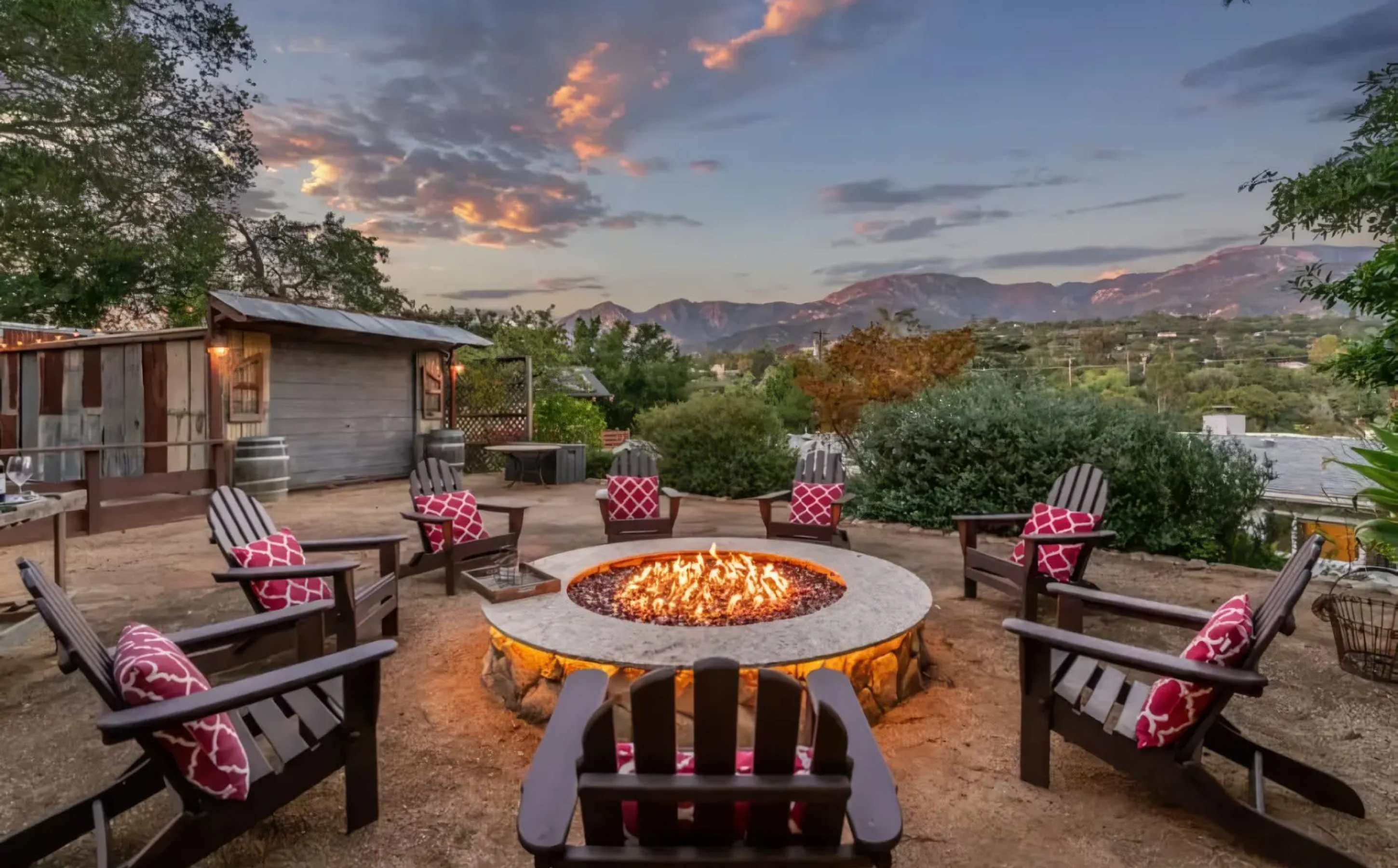 Santa Barbara home exterior with firepit at dusk