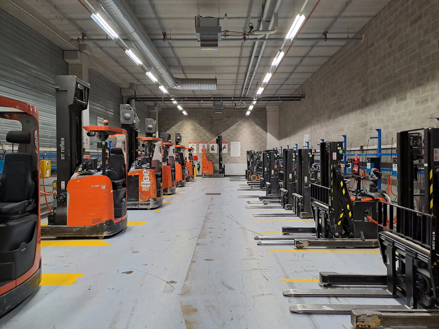 Forklift moving palletized goods in a warehouse aisle