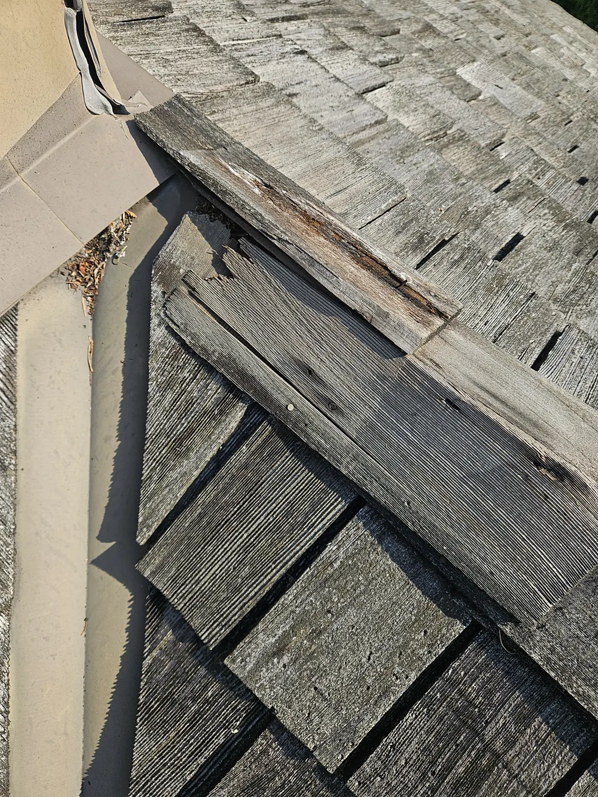 Rotted cedar shakes at a roof edge in Metro Vancouver before repair
