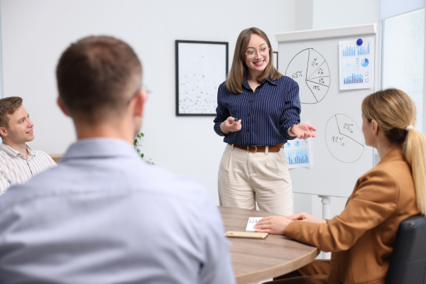 A business owner leading a small team meeting, symbolising leadership growth.