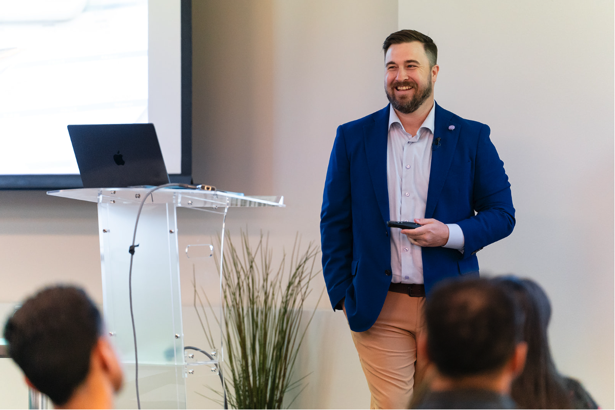 Speaker in a blue blazer at a lectern