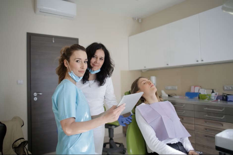Dentist showing a tablet to an assistant in the clinic