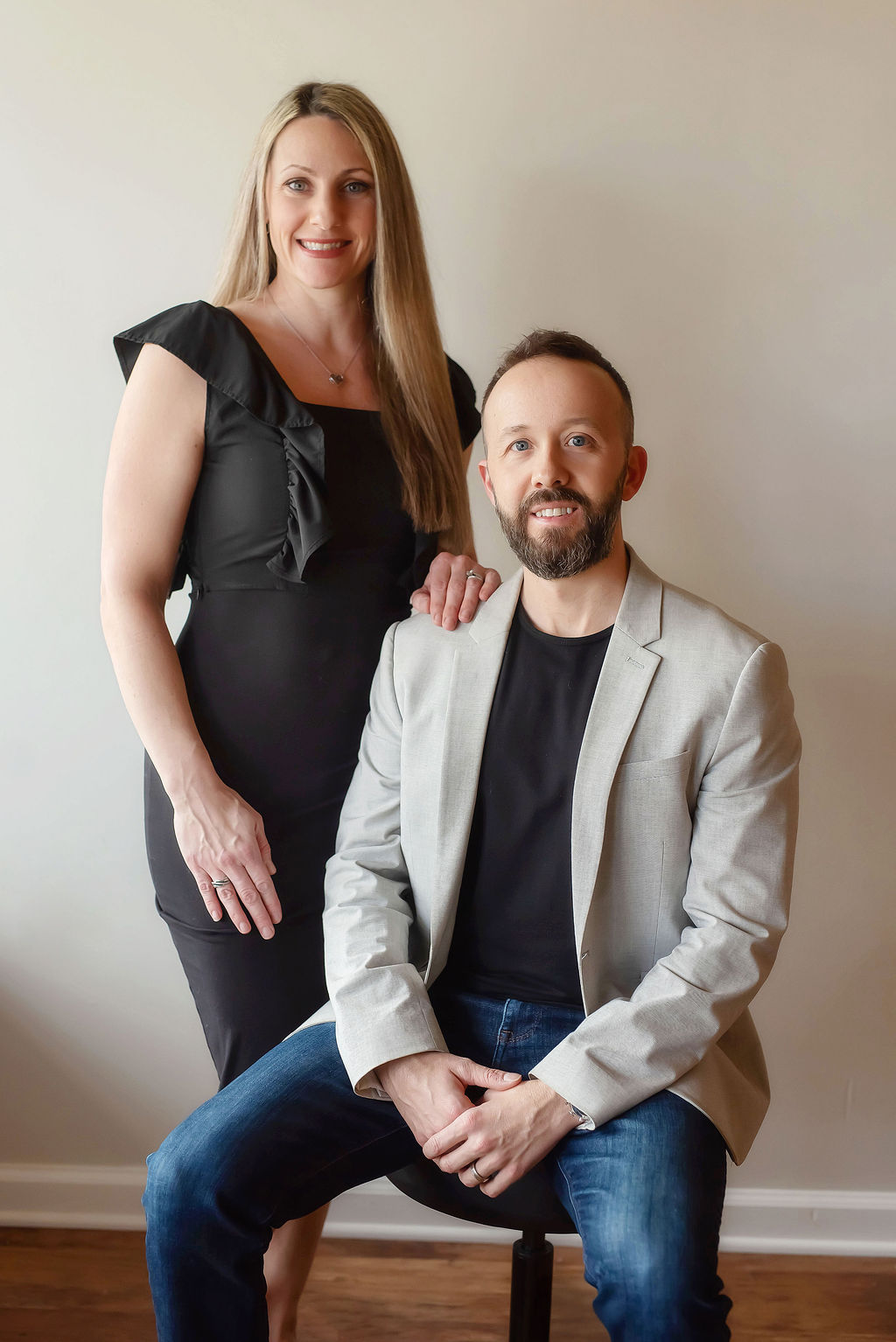 Portrait of Dr. Avery Hart, DC, a mid-40s clinician with a warm, confident smile in a professional clinical office setting.