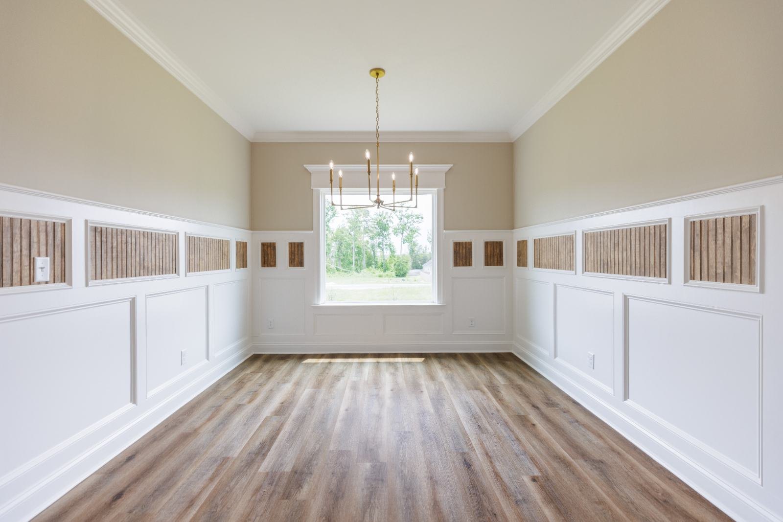Dining room with white wainscoting and a stained wood inlay band