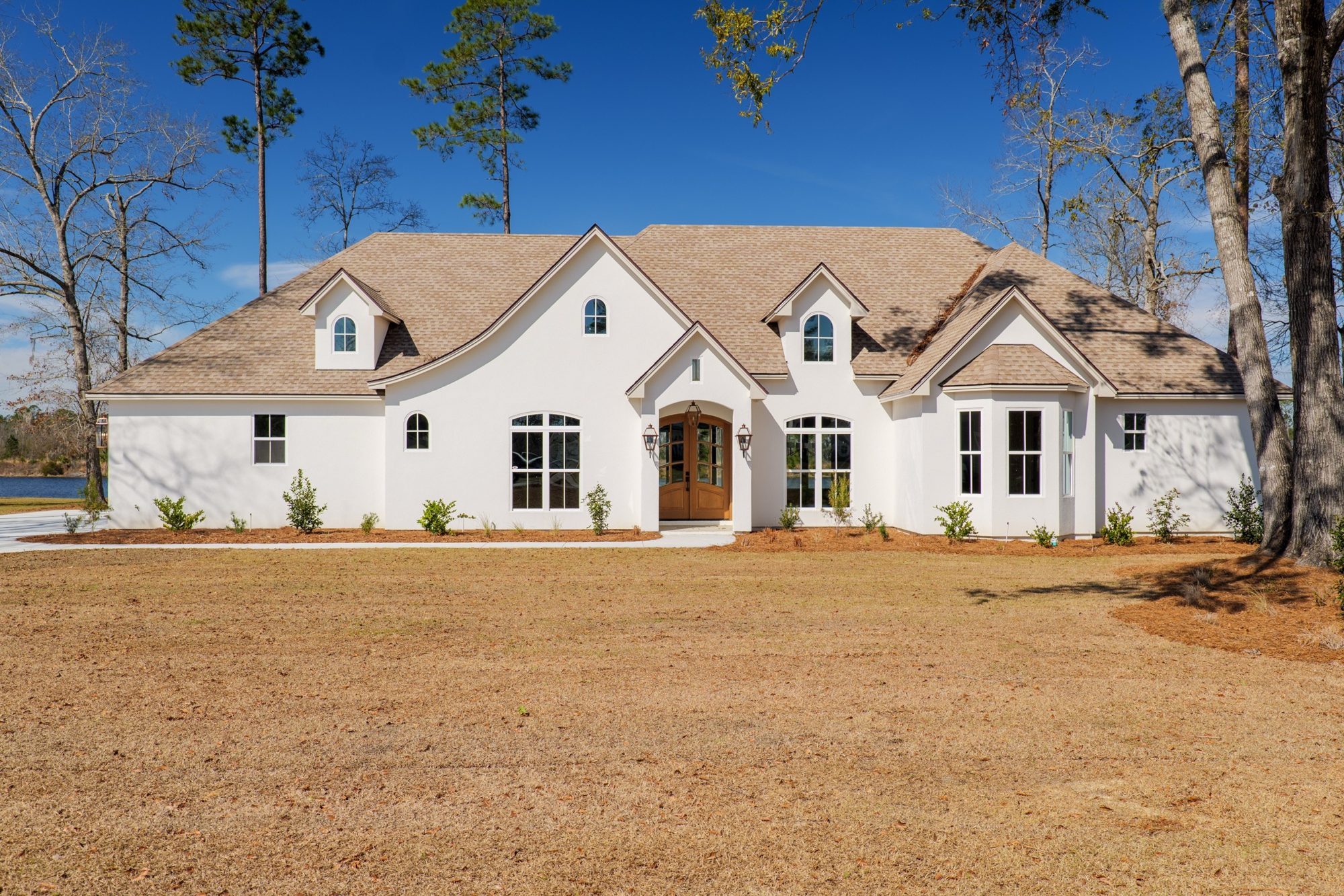 Front of a white LaCatalina home with a stone and stucco facade