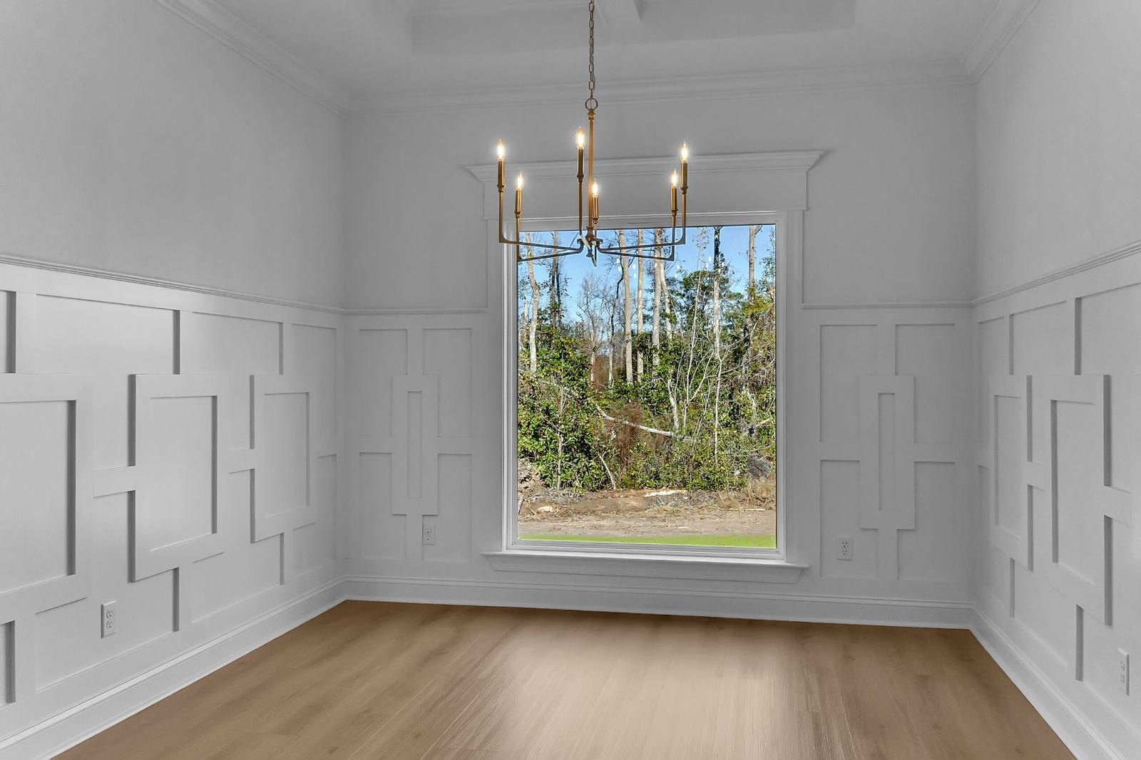 Dining room with geometric wall paneling around a large window