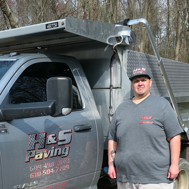 H&S Paving owner standing beside the company dump truck
