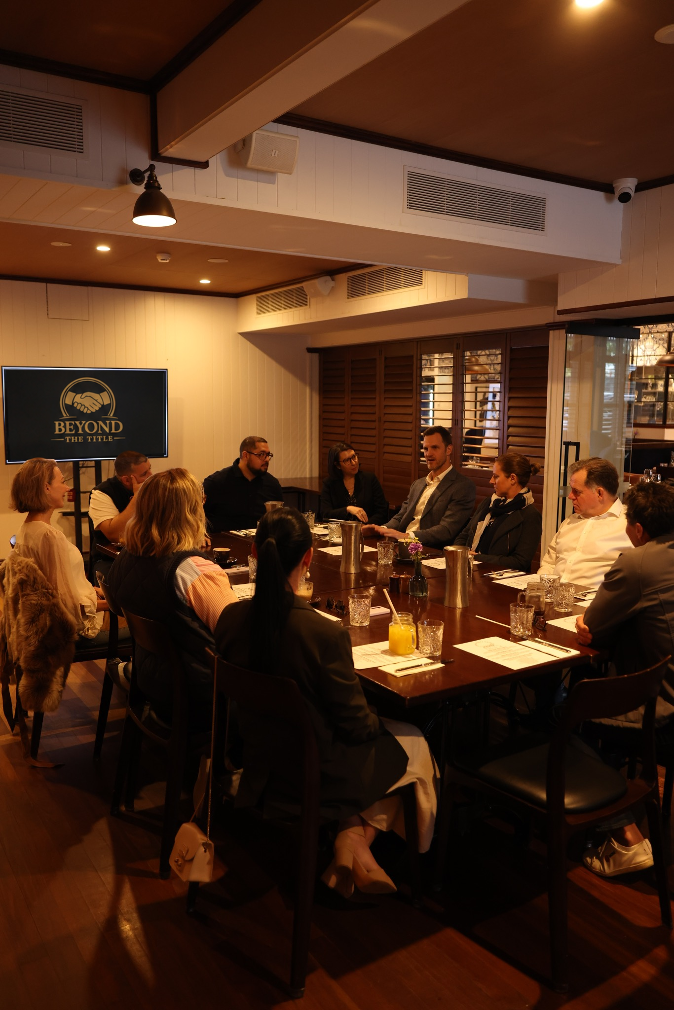 Guests sharing conversation around the Beyond The Title breakfast table