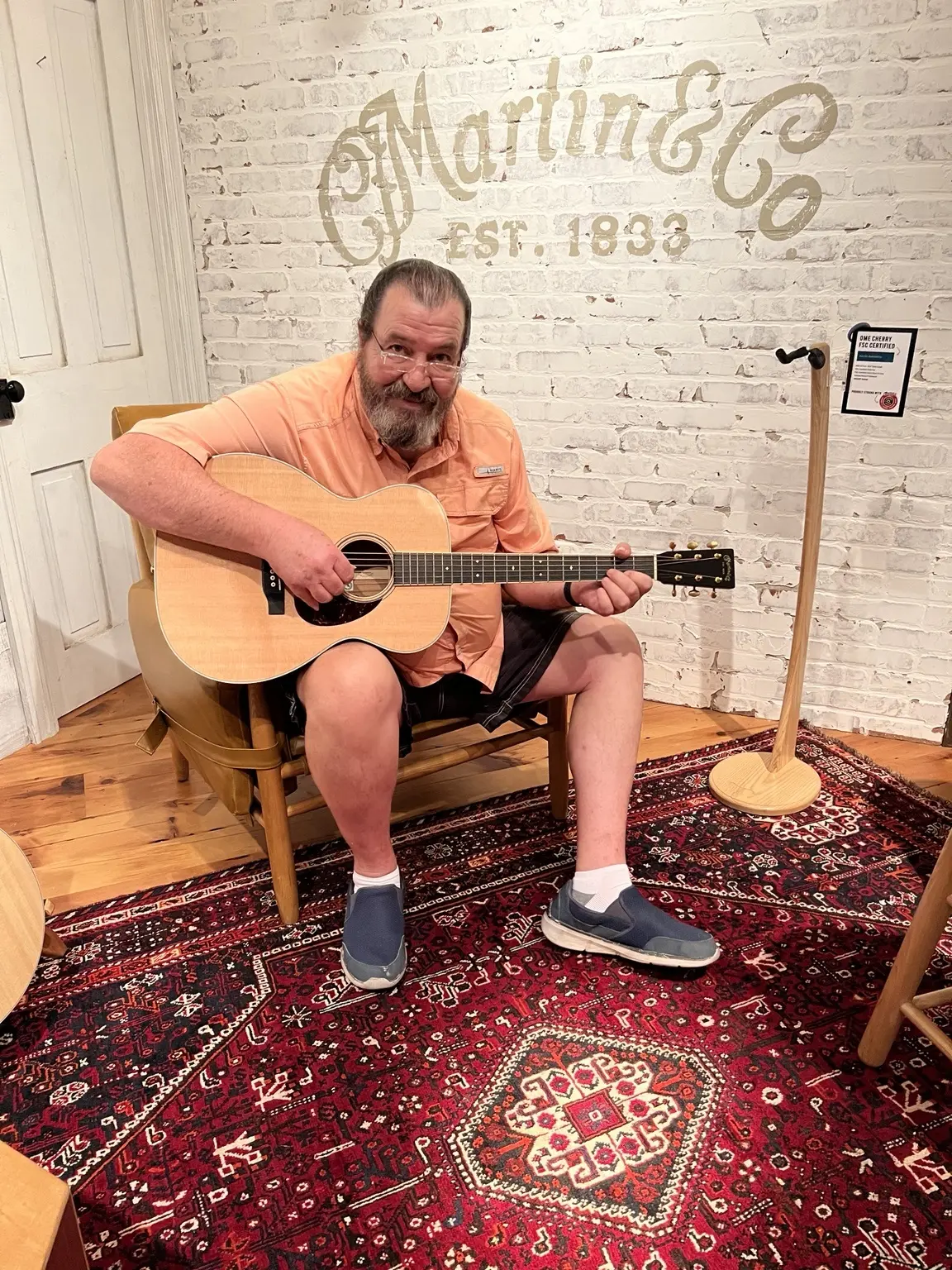 Payton Brown playing a C. F. Martin acoustic guitar