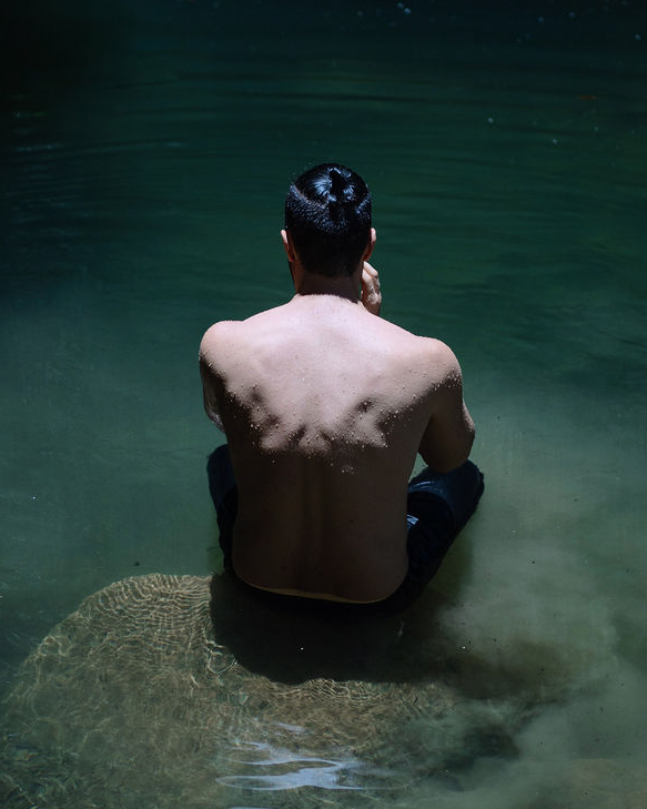 Luke seated in water in contemplative masculine initiation