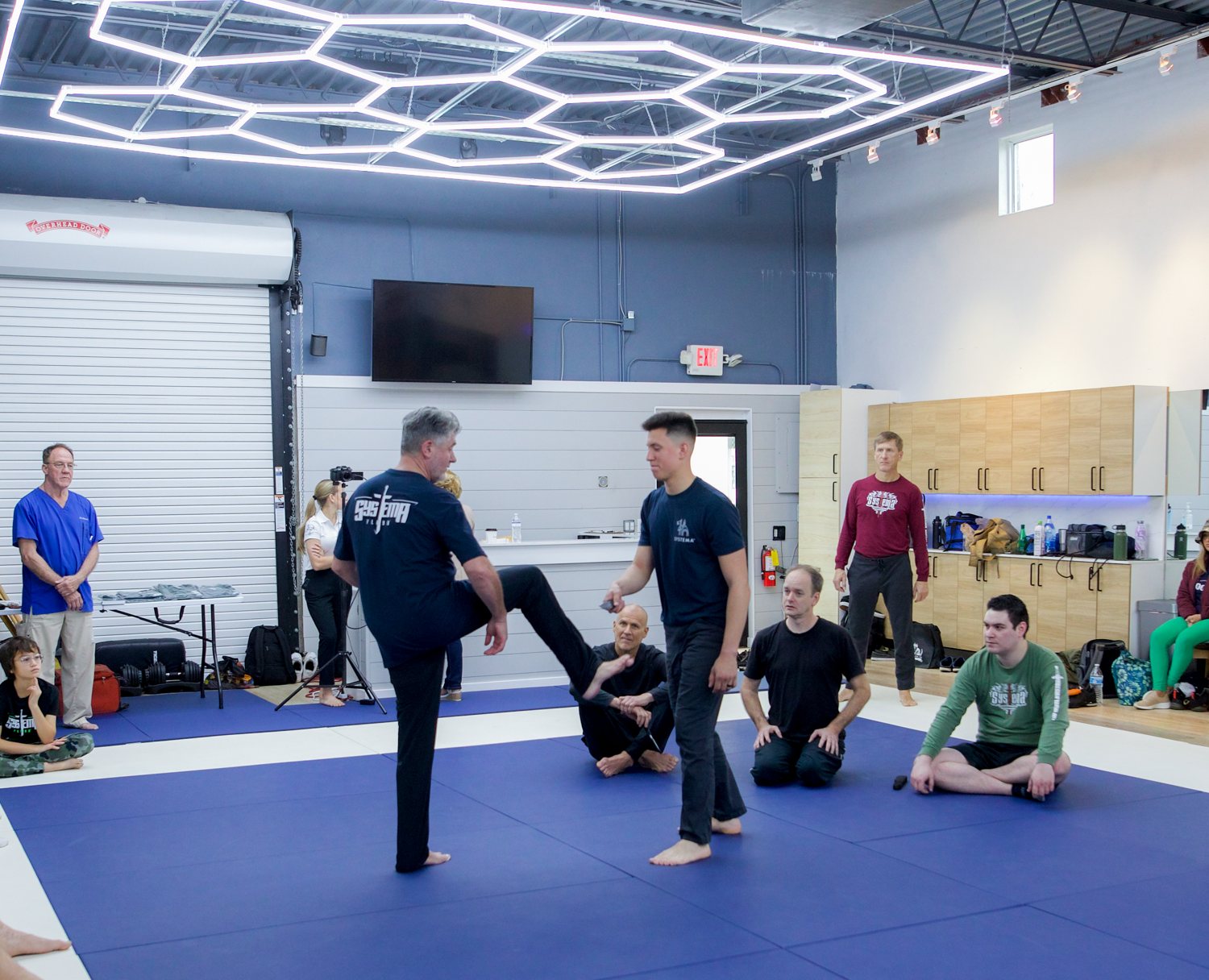 A standing demonstration in front of the group during a Systema seminar