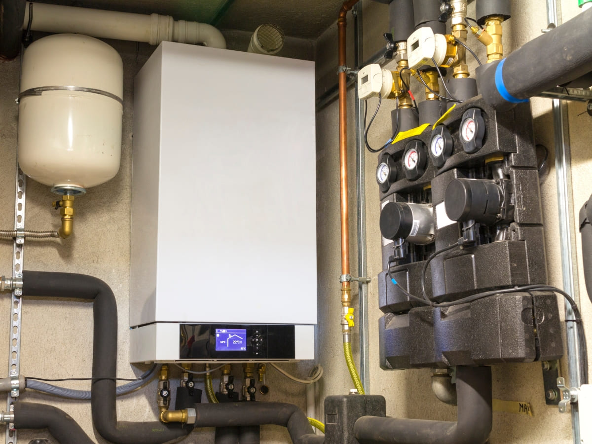 High-efficiency heating system installed indoors with a modern boiler, expansion tank, and multiple connected pipes