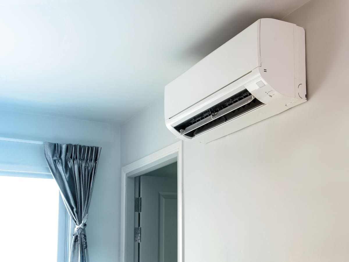 Wall-mounted ductless air conditioner installed inside a home with clean, minimalist interior design