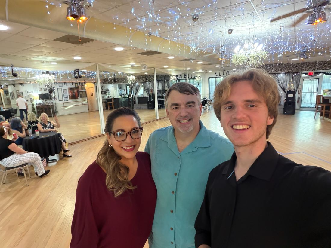 Smiling students and instructors together at the studio