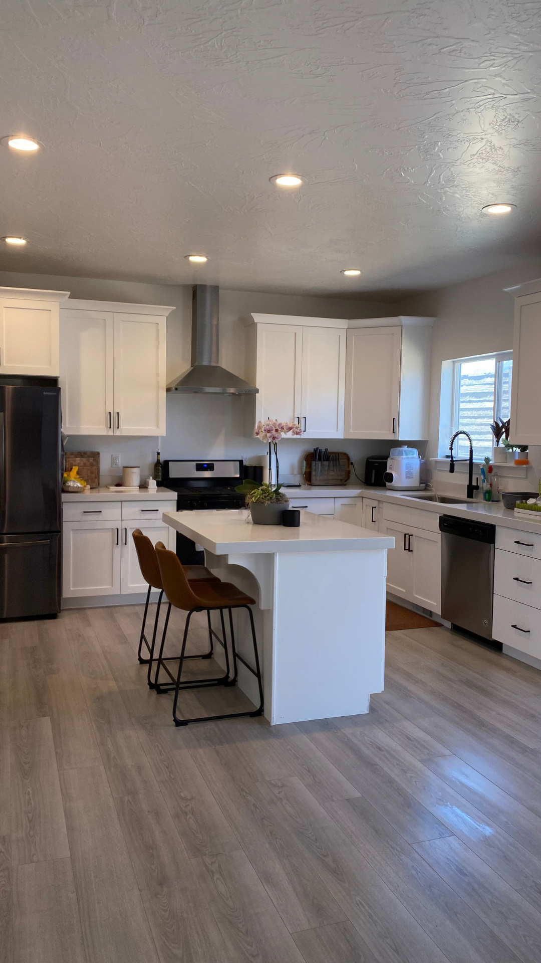 Spotless white kitchen with island cleaned by Boujee Cleaning Services in Utah