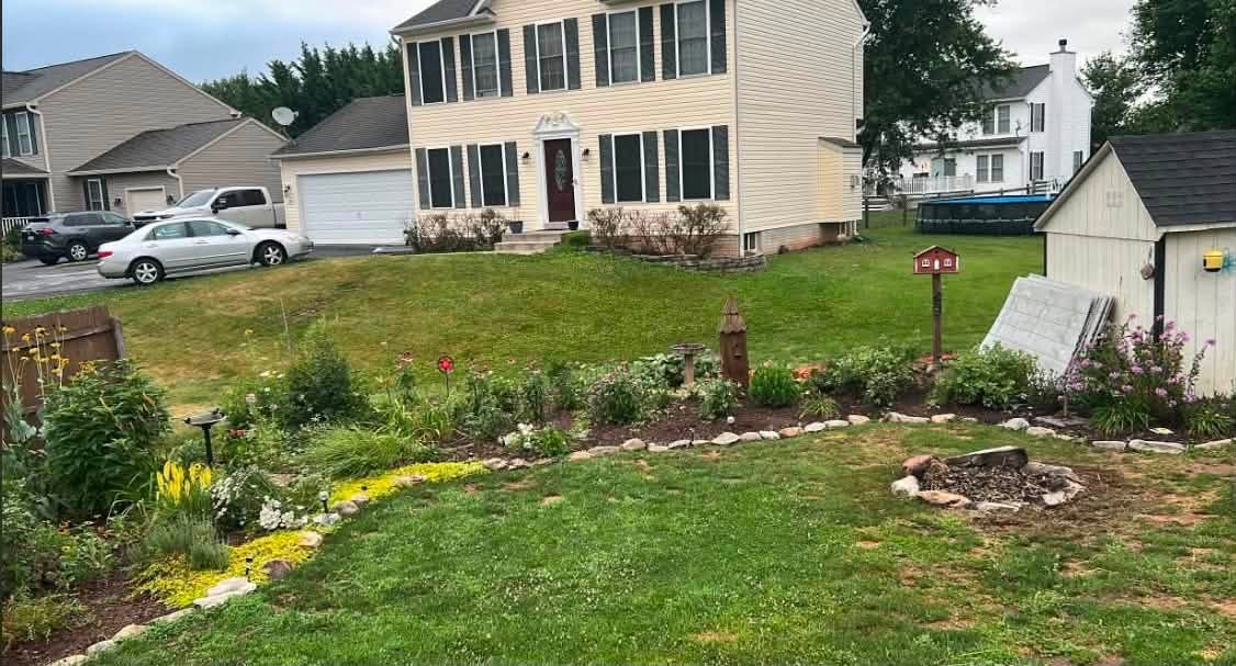 Freshly cleaned-up front yard and garden bed at a Carroll County, MD home after a JT Property Services storm cleanup