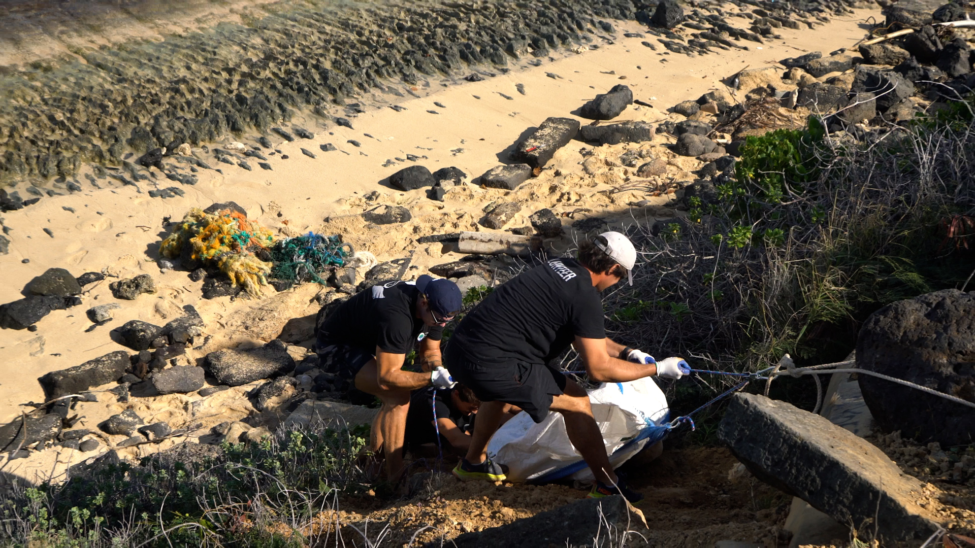 Our cleanup team removing derelict fishing gear from a remote coastline on Oahu, Hawaii