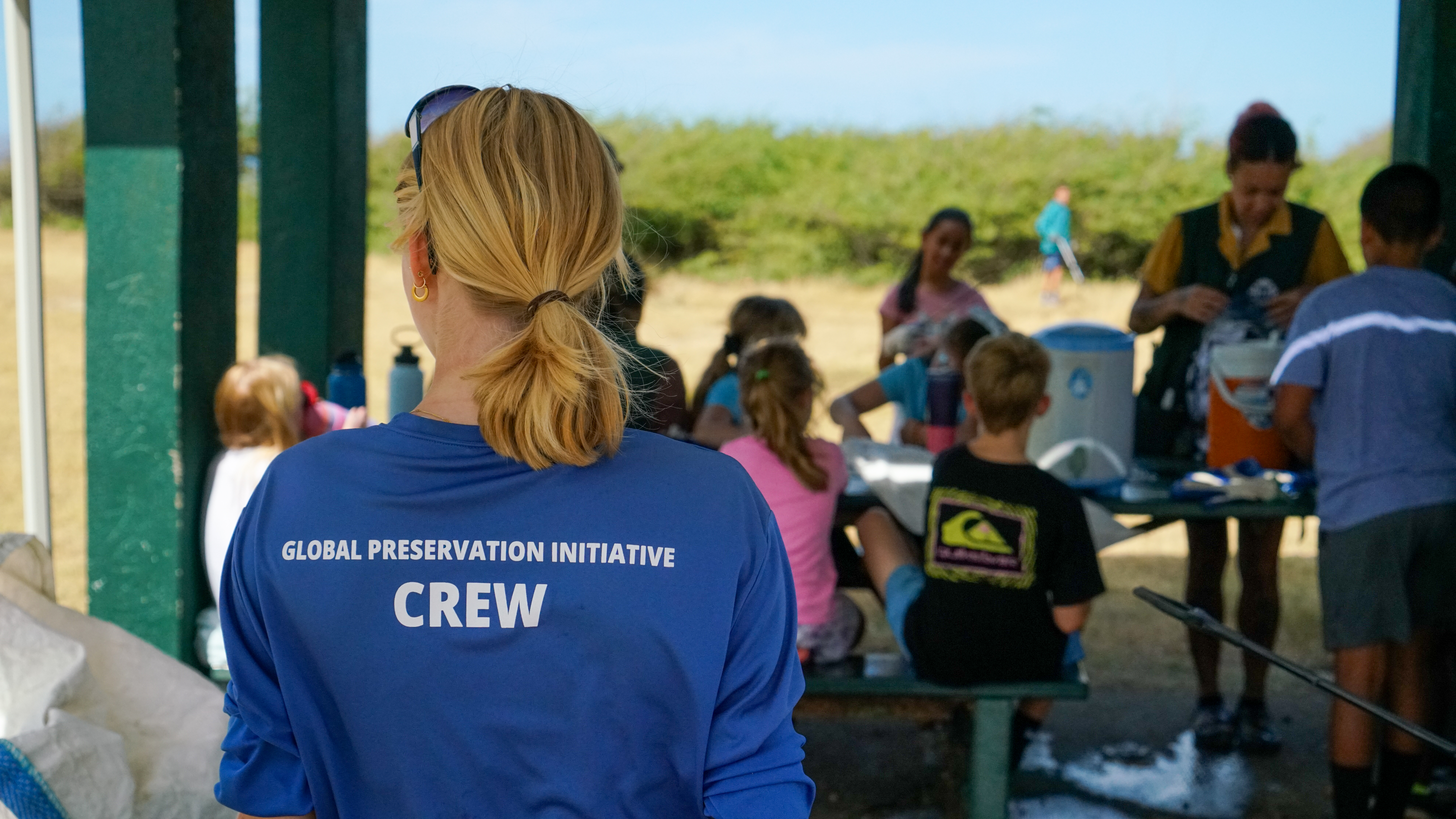 Our education team sand sifting plastic with a student on Oahu, Hawaii