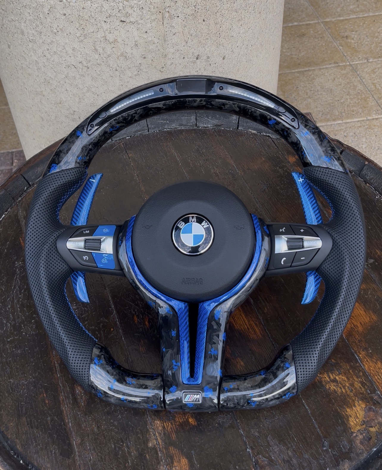 Ocean Blue forged carbon steering wheel with blue flakes and blue paddle shifters