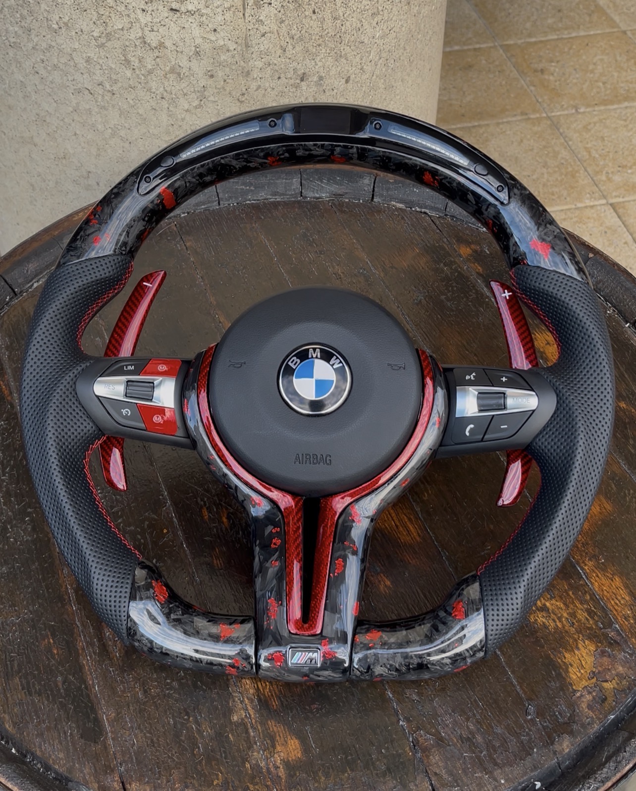 Crimson Red forged carbon steering wheel with red flakes and red paddle shifters