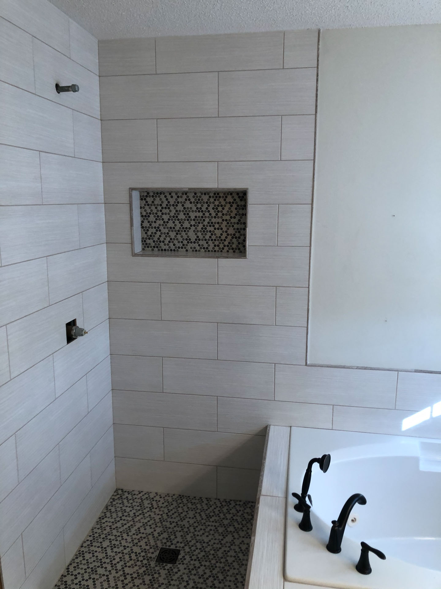 Bathroom with floor-to-ceiling natural Carrara marble walls and polished chrome fixtures