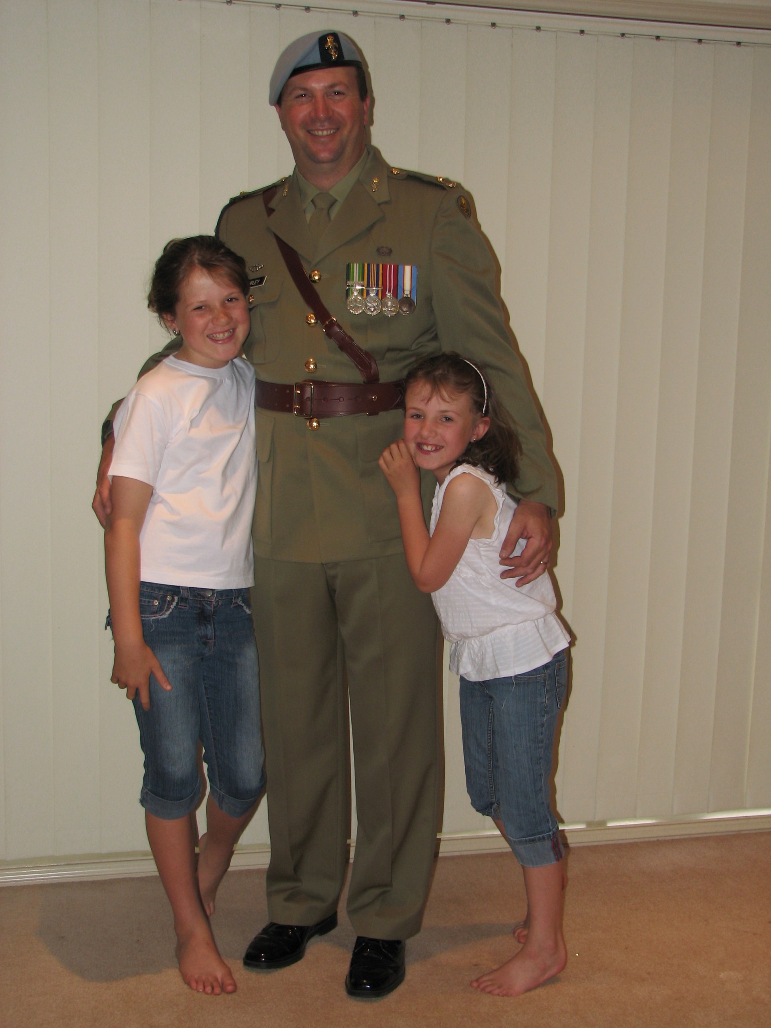 Morgan and Danika Burley standing with their father Darryl Burley, an Australian Army soldier in uniform. Morgan and Danika Burley standing with their father Darryl Burley, an Australian Army soldier in uniform.